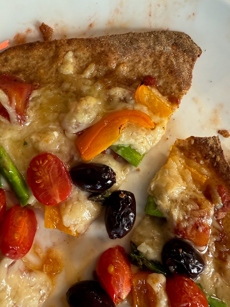 Vegetarian flatbread pizza with tomatoes, olives, and bell peppers