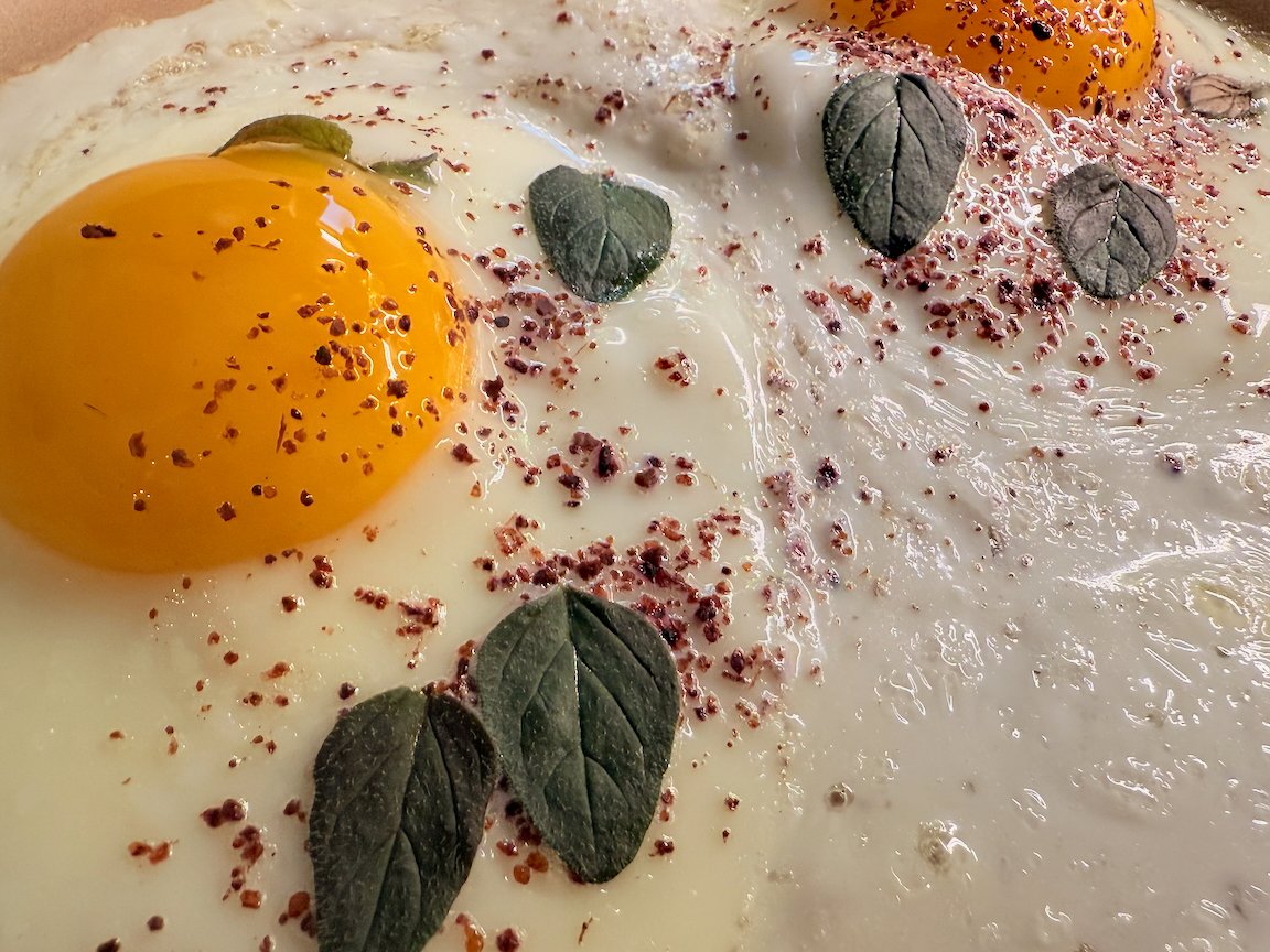 Sunny side up eggs with herbs and spices on top