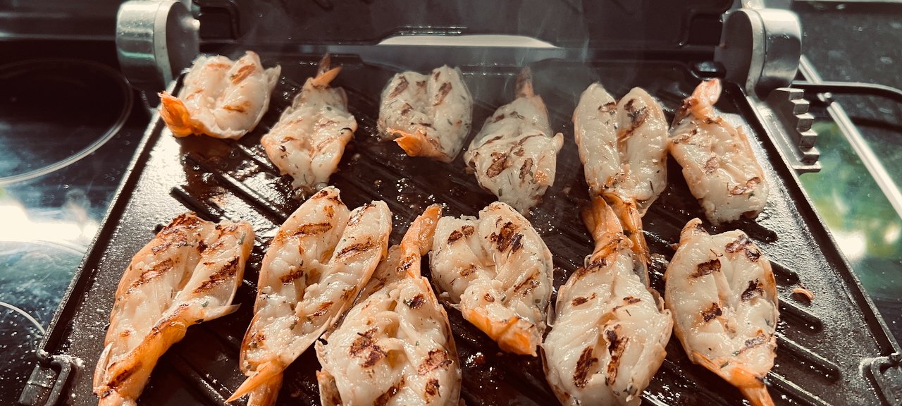 Shrimp grilling on a Breville electric grill with visible steam