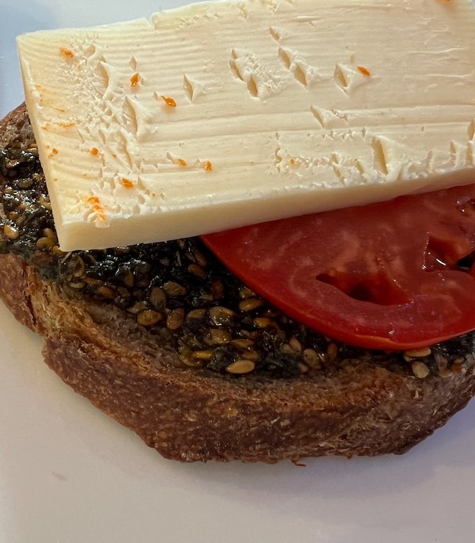 Za'atar toast with fresh tomato slice and block of cheese